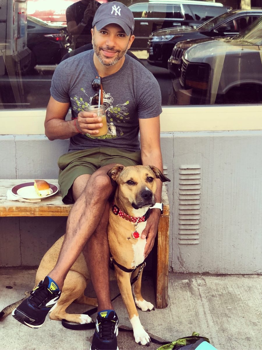 Eddie and Maya on a bench outside a cafe
